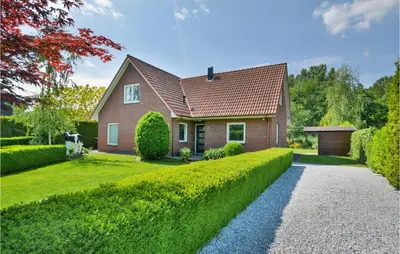 a house with a green hedge in front of it at Horsterhuis in Zeewolde