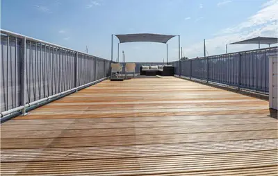 a wooden boardwalk on a building with a roof at Aqualiving in Aalsmeer