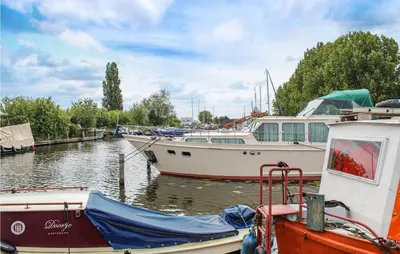 two boats are docked at a marina on the water at Huis Nr 1 in Woubrugge