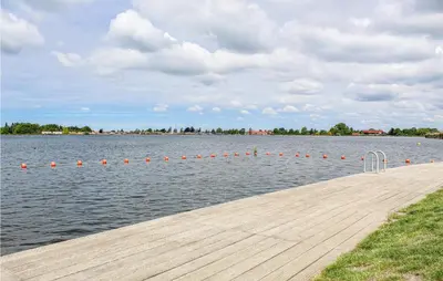 a dock with orange balls in the water at Huis Nr 1 in Woubrugge