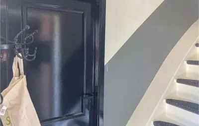 a black door in a room with a stair case at Gorgeous Home In Bunschoten-Spakenb in Bunschoten