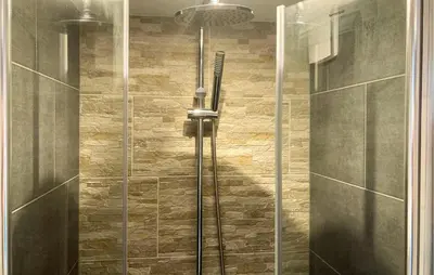 a shower with a glass door in a bathroom at Gorgeous Home In Bunschoten-Spakenb in Bunschoten