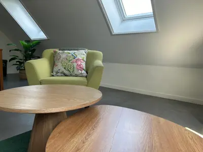 a living room with a chair and a table at B&B Zunderdorp in Amsterdam
