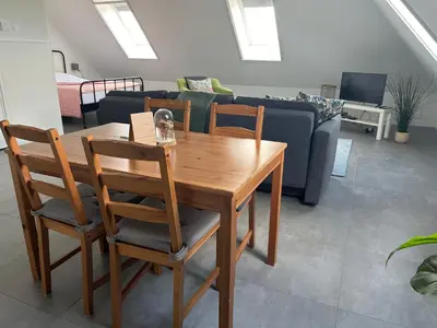 a living room with a wooden table and chairs at B&B Zunderdorp in Amsterdam