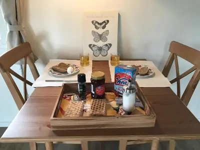 a wooden table with a tray of food on it at B&B Zunderdorp in Amsterdam