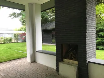 a brick fireplace in the side of a house at Fiddler's Hoorn in Zwaag