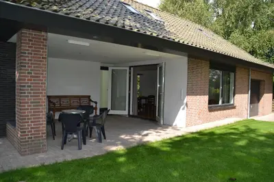 a patio with a table and chairs on it at Fiddler's Hoorn in Zwaag