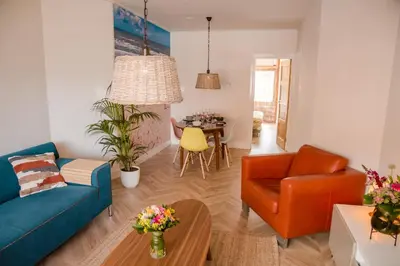 a living room with a couch and a table at Beachhouse Anna, 1 minute walk to the beach and centre of Katwijk, Free private parking next to the house ! in Katwijk aan Zee