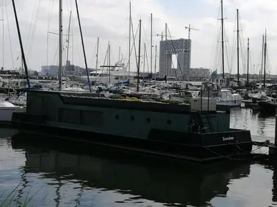 a boat is docked in a harbor with other boats at loft boat in Amsterdam
