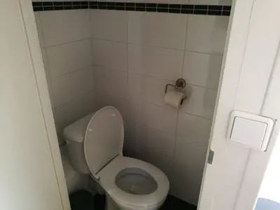 a small bathroom with a toilet and a roll of toilet paper at loft boat in Amsterdam