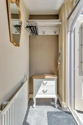 a dressing room with a white dresser and a mirror at Appartement RoMi in Koedijk