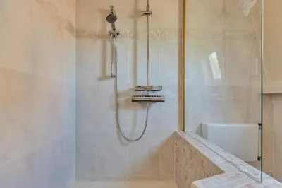 a bathroom with a shower and a bath tub at Appartement RoMi in Koedijk