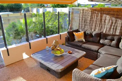 a living room with a couch and a table at Beachy Chic Zandvoort in Zandvoort