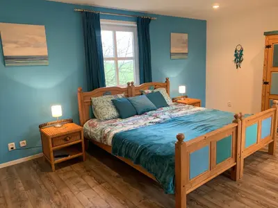 a bedroom with a bed with blue walls at B&B De Hooiberg Edam-Volendam in Edam