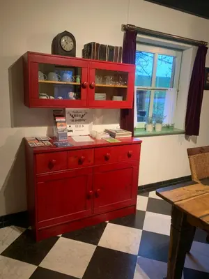 a red cabinet with a clock on top of it at B&B De Hooiberg Edam-Volendam in Edam