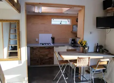 a kitchen with a table and chairs in a room at Have a nice stay! - Beach Cottage free parking in Noordwijk aan Zee