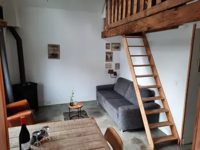 a living room with a loft bed and a couch at Have a nice stay! - Beach Cottage free parking in Noordwijk aan Zee