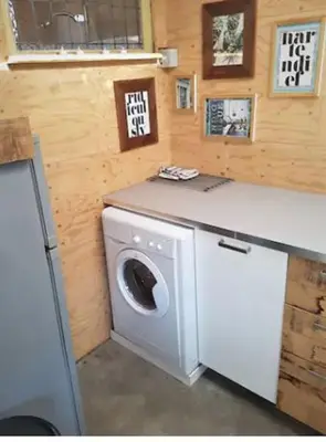 a washer and dryer in a tiny house at Have a nice stay! - Beach Cottage free parking in Noordwijk aan Zee