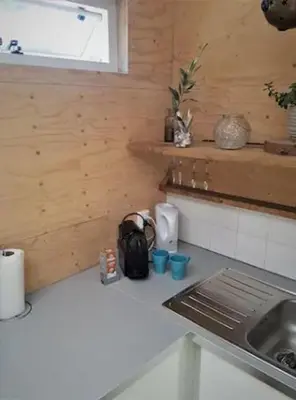 a kitchen with a sink and a counter top at Have a nice stay! - Beach Cottage free parking in Noordwijk aan Zee