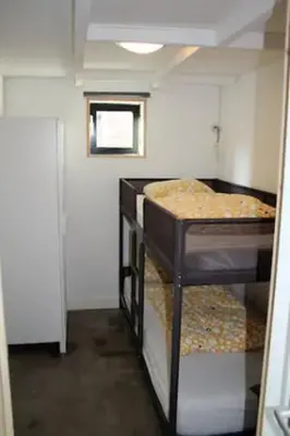 a small room with two bunk beds in it at Have a nice stay! - Beach Cottage free parking in Noordwijk aan Zee