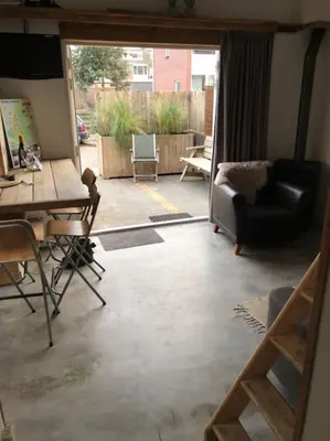 a living room with a view of a patio at Have a nice stay! - Beach Cottage free parking in Noordwijk aan Zee
