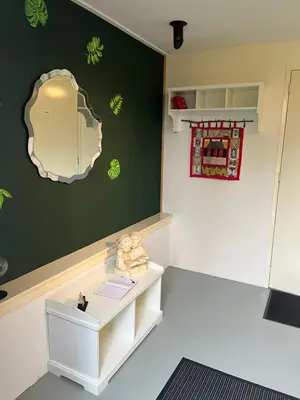 a room with a table and a mirror on the wall at De Loft in Zuid-Scharwoude
