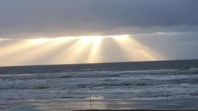 a ray of light shining over the ocean with waves at Beach Studio, No Sea View, Public Paid Parking in Zandvoort