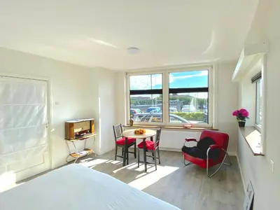 a bedroom with a bed and a table and chairs at Who's Anton for you or two, Monnickendam near Amsterdam in Monnickendam