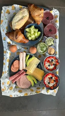 a tray of different types of food on a table at Luxe B&B 