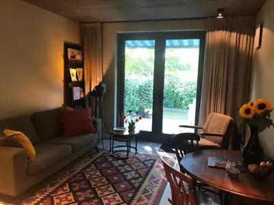 a living room with a couch and a table at Luxe B&B 