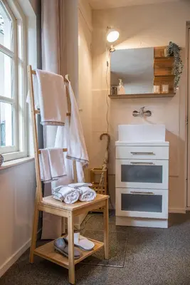 a bathroom with a towel rack and a sink at Casa Allegria - Zuiderbosch in Bergen