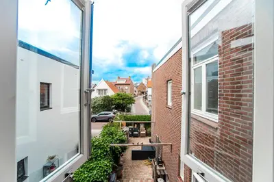 an apartment balcony with a view of a street at Zonnebloem in Zandvoort