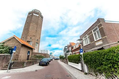 a city street with a clock tower in the distance at Zonnebloem in Zandvoort