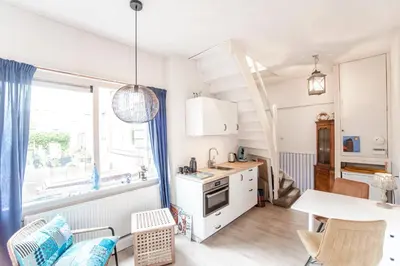 a kitchen with a table and a dining room at Zonnebloem in Zandvoort