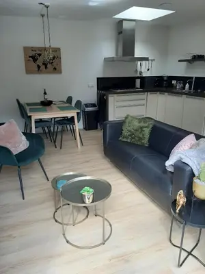 a living room with a couch and a table at Zomerhuis Carolina in Egmond aan Zee
