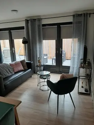 a living room with a couch and a table at Zomerhuis Carolina in Egmond aan Zee