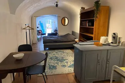 a living room with a room with a bed and a table at Werfkelder aan de Oudegracht in Utrecht