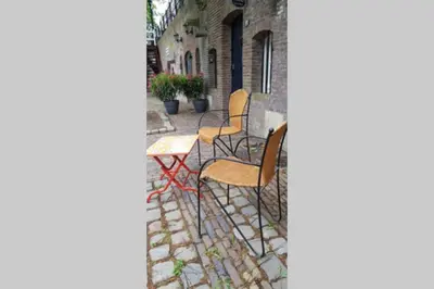 a patio with chairs and a table on a street at Werfkelder aan de Oudegracht in Utrecht