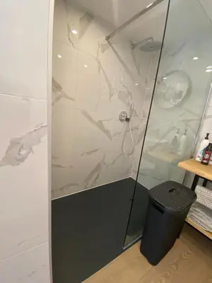 a shower with a glass door next to a trash can at Style Gardenhouse Zwanenburg near AMSTERDAM, HAARLEM, ZANDVOORT in Zwanenburg
