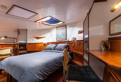 a bedroom in a boat with a bed in it at Anna Houseboat in Amsterdam