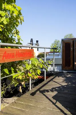 a sign that says alpha houston next to a building at Anna Houseboat in Amsterdam