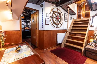 a room with a staircase and a room with a table at Anna Houseboat in Amsterdam