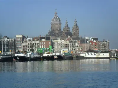 a group of boats docked in a harbor with buildings at Anna Houseboat in Amsterdam