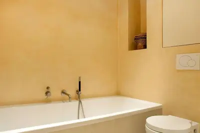 a bathroom with a bath tub and a toilet at The Little Townhouse in Amsterdam