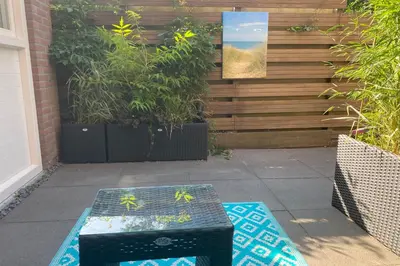 a table in front of a wall with plants at Good Vibes Romantic Studio incl free private parking in Zandvoort