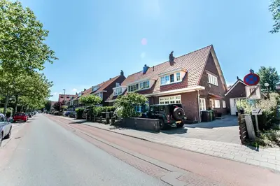 a street with a house and a truck parked on the street at Good Vibes Romantic Studio incl free private parking in Zandvoort