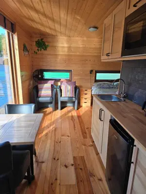 a kitchen and living room of a tiny house at Mar&Mar Houseboat Studio in Amsterdam