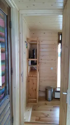a small wooden sauna with a stove in it at Mar&Mar Houseboat Studio in Amsterdam