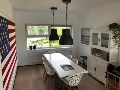 a dining room with a table and an american flag at The Boathouse with boat in Aalsmeer