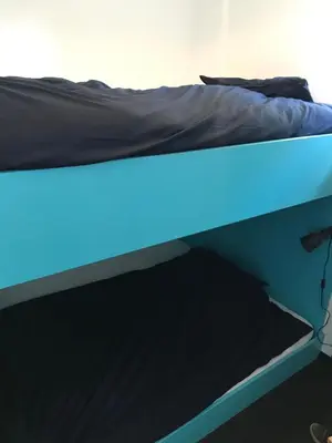 a bed with a blue light on top of it at The Boathouse with boat in Aalsmeer